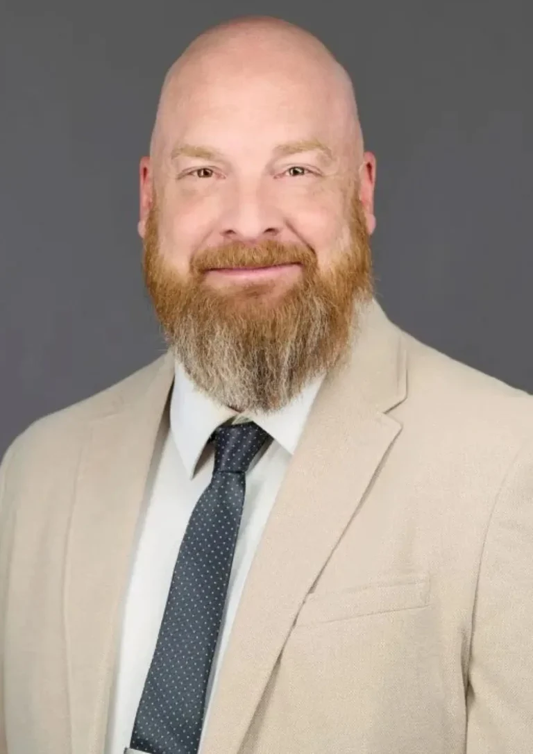 Experienced personal injury attorney in a tan suit and navy tie, providing expert legal representation for accident victims at Malnar Law.