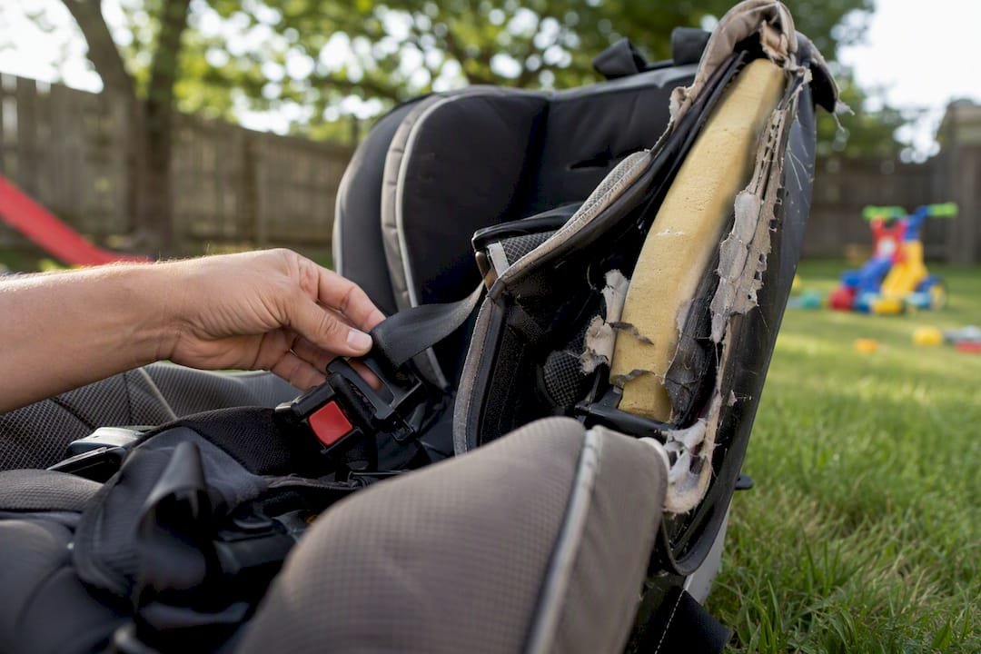 Close-up of damaged child car seat inspected