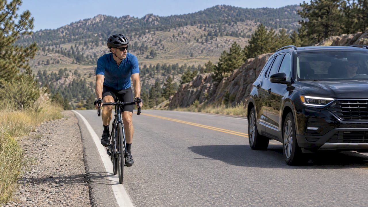 Cyclist riding as car passes with clearance